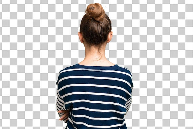 Young blonde woman over isolated chroma key background in back position