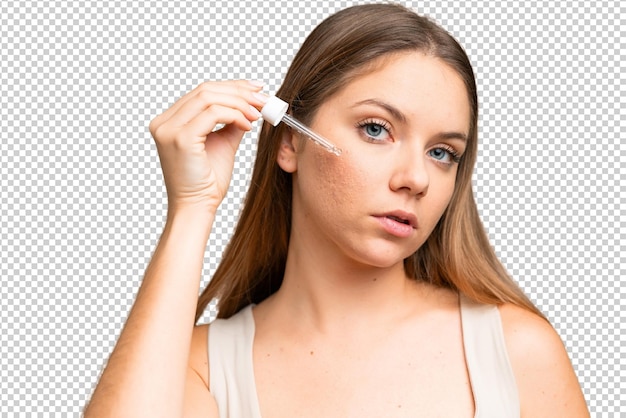 Young blonde woman over isolated chroma key background holding a serum Close up portrait