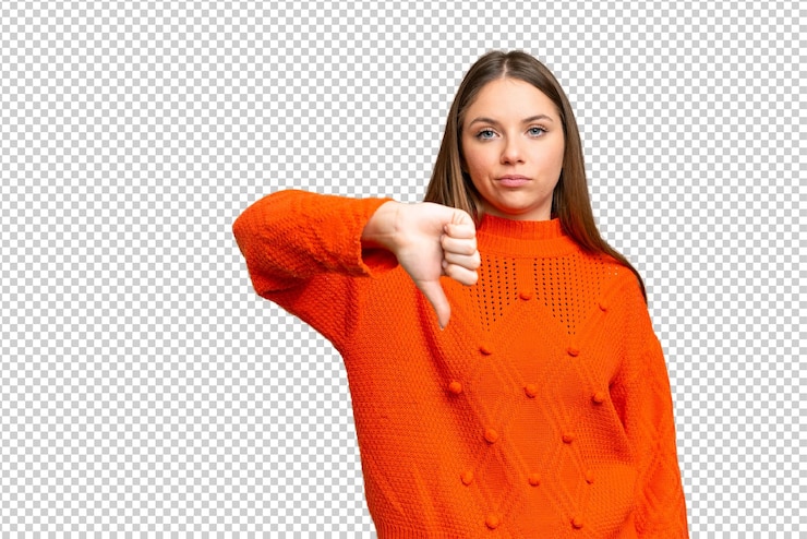 PSD young blonde woman over isolated chroma key background showing thumb down with negative expression