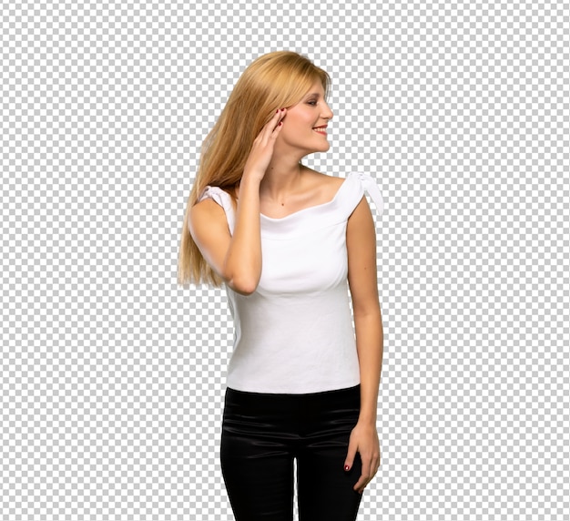 PSD young blonde woman listening to something by putting hand on the ear