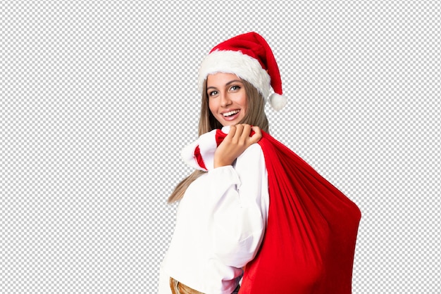 Young blonde woman picking up a bag full of presents