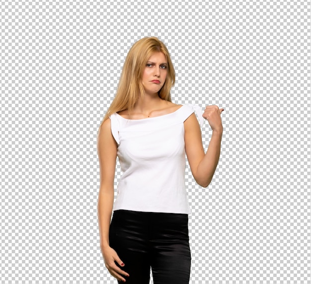 Young blonde woman unhappy and pointing to the side