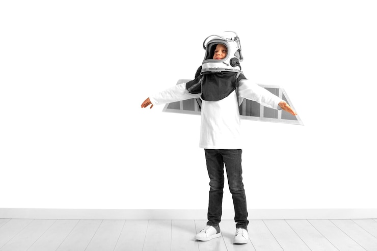 PSD a young boy imagines that he is flying in a pilots helmet