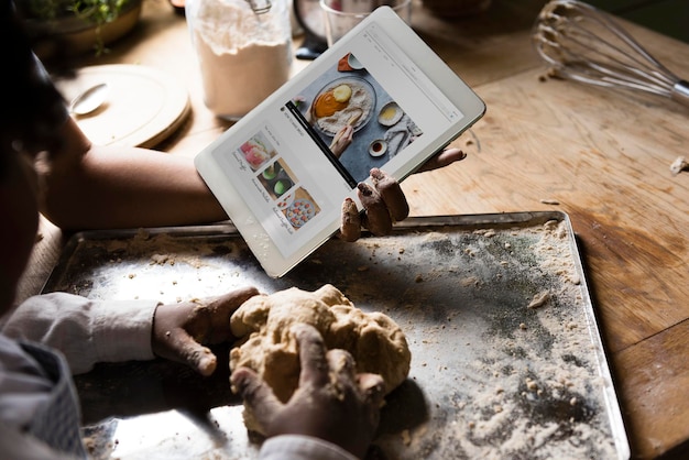 Young boy leaning to bake with his mother