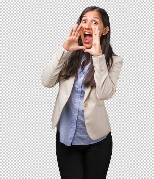PSD young business indian woman screaming happy, surprised by an offer or a promotion, gaping, jumping and proud