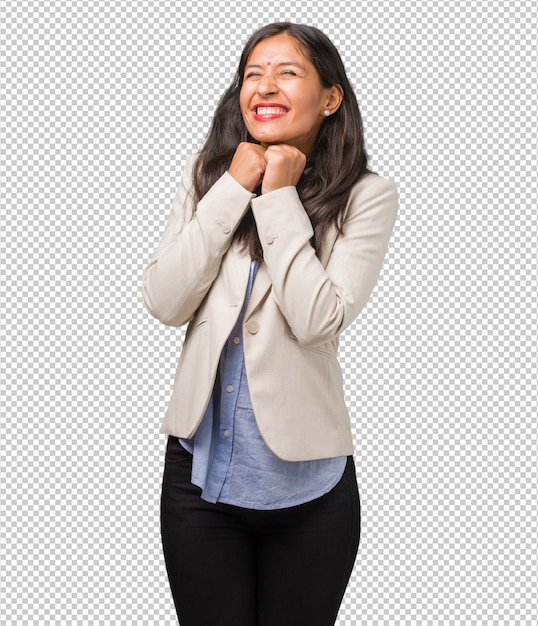 Young business indian woman very happy and excited, raising arms, celebrating a victory or success, winning the lottery