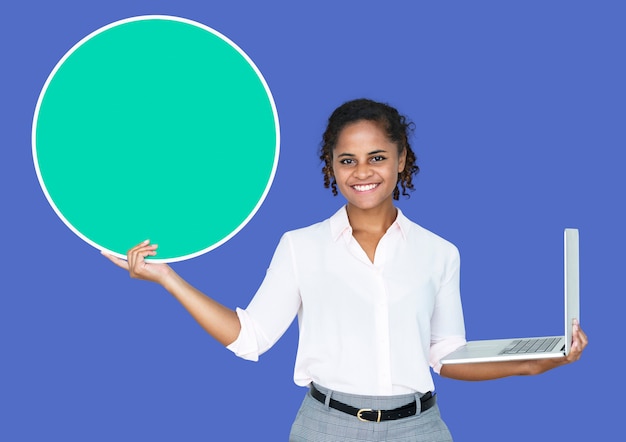 Young businesswoman holding a blank circle and a laptop