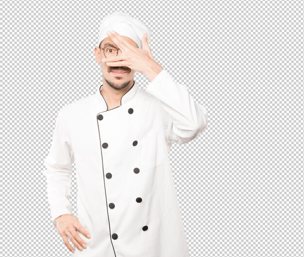 Young chef covering his eyes with his hands