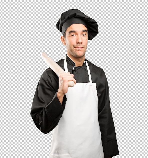 Young chef using a cooking utensil with a doubt gesture