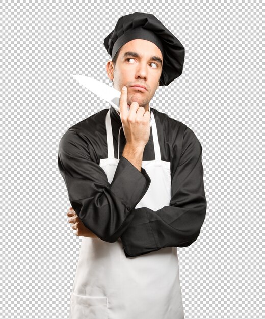 PSD young chef using a cooking utensil with a doubt gesture