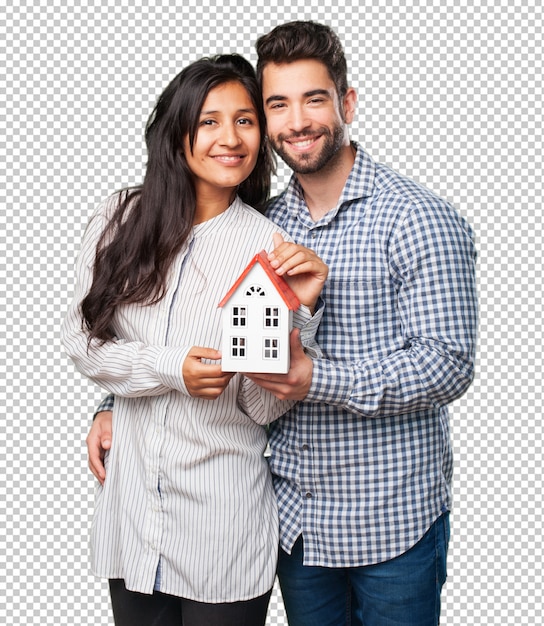 Young couple holding a house