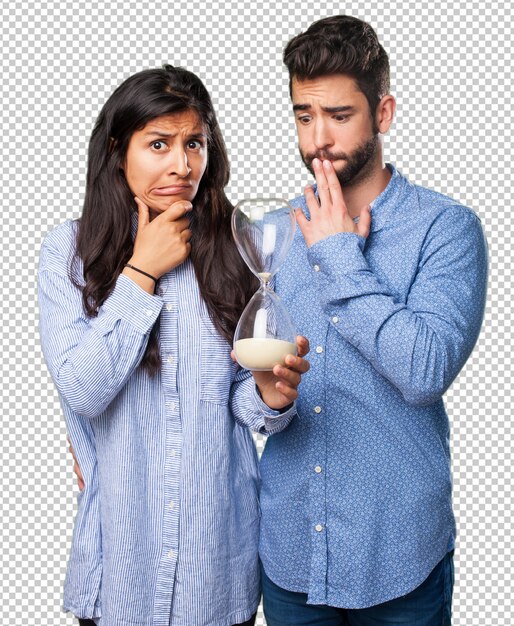 PSD young couple holding a sand timer