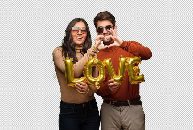 Young couple in valentines day doing a heart shape with hands