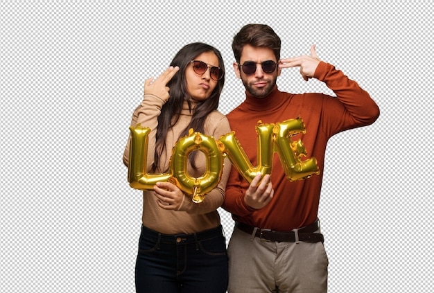 Young couple in valentines day doing a suicide gesture