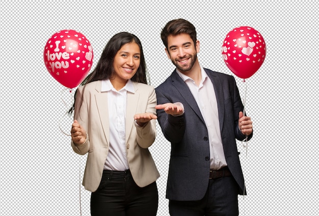 Young couple in valentines day holding something with hands