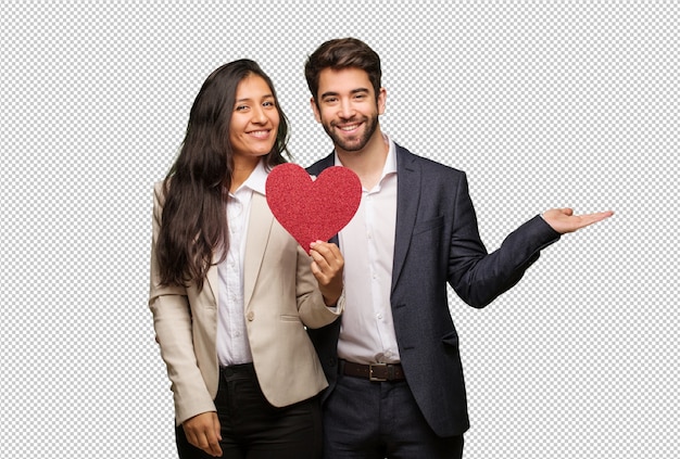 young couple in valentines day holding something with hands
