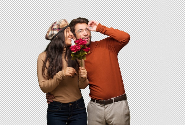 Young couple in valentines day making the gesture of a spyglass