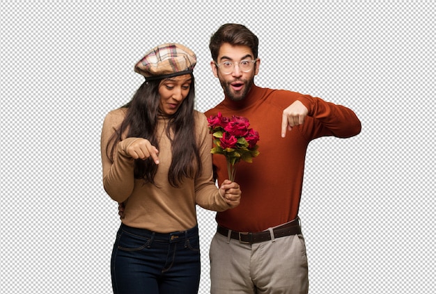 PSD young couple in valentines day pointing down