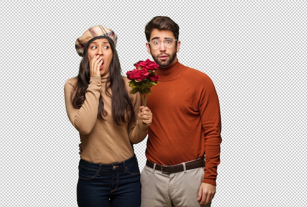 Young couple in valentines day very scared and afraid hidden