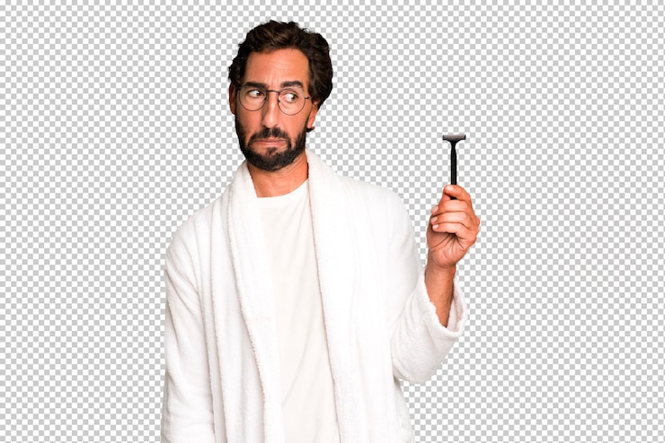 PSD young crazy bearded and expressive man wearing bathrobe and shaving beard concept