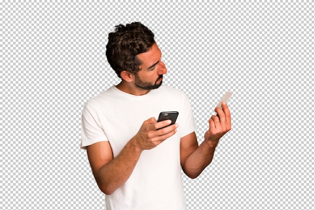 Young crazy bearded and expressive man shopping online with a telephone and a credit card