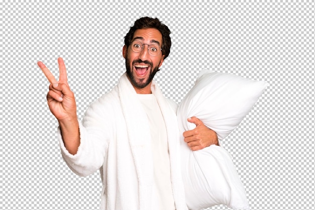 Young crazy bearded and expressive man wearing bathrobe and a pillow