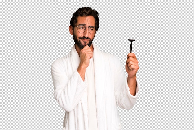 Young crazy bearded and expressive man wearing bathrobe and shaving beard concept