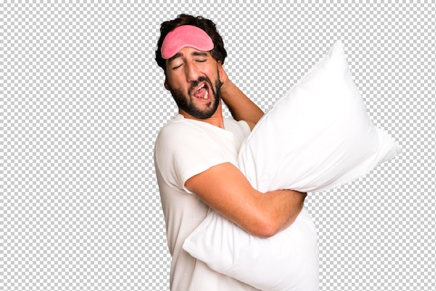 PSD young crazy bearded and expressive man wearing pajamas and eye mask and with a pillow