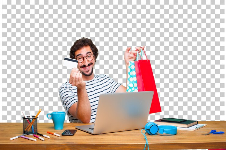 Young crazy graphic designer on a desk with a laptop and pay, buying or money concept