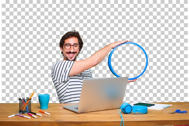 Young crazy graphic designer on a desk with a laptop and with a frame