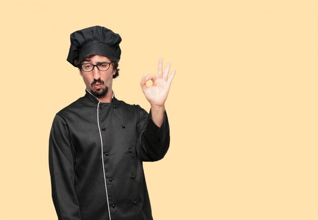 PSD young crazy man as a chef making ok gesture