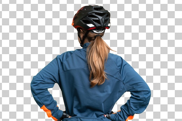 Young cyclist girl over isolated chroma key background in back position