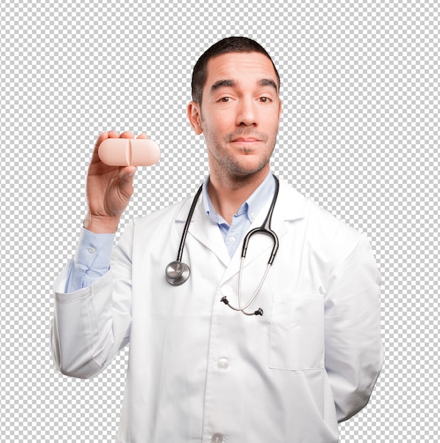 PSD young doctor holding a pill