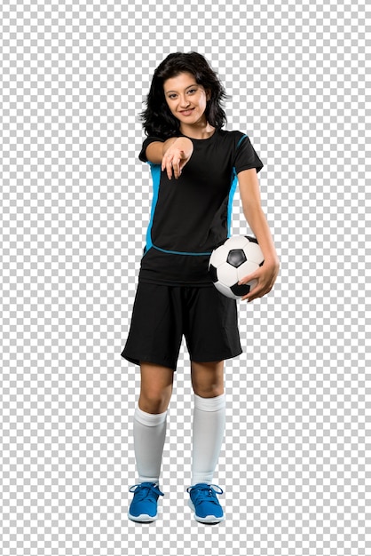 PSD young football player woman points finger at you with a confident expression