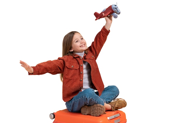 PSD young girl playing with toy airplane for traveling