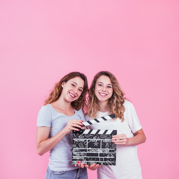 Young girls holding clapperboard