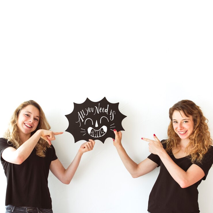 PSD young girls holding speech bubble slate mockup