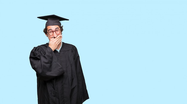 PSD young graduated man laughing out loud with head tilted backwards and happy, cheerful expression