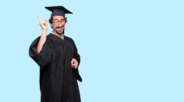 young graduated man smiling and dancing to fun, lively disco music