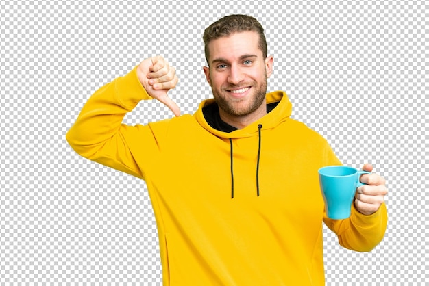 Young handsome blonde man holding cup of coffee over isolated background proud and selfsatisfied