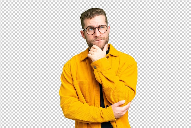 Young handsome blonde man over isolated chroma key background having doubts and thinking