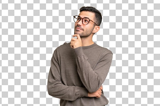 Young handsome caucasian man over isolated background and looking up