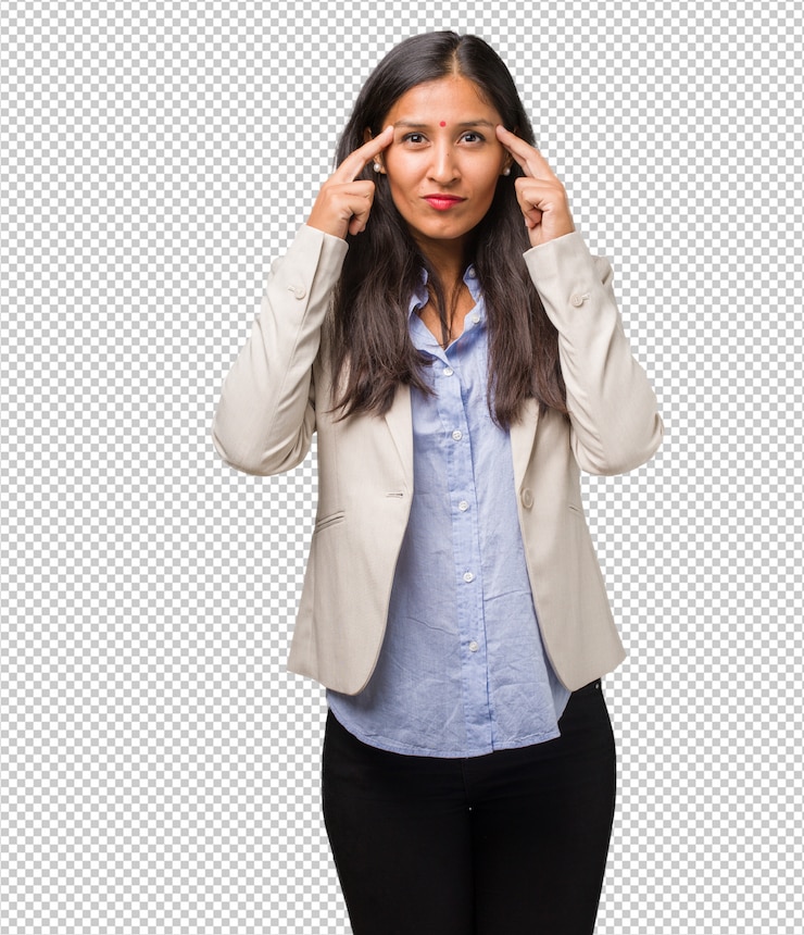 PSD young indian woman man making a concentration gesture, looking straight ahead focused on a goal