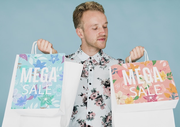 Young male checking shopping bags