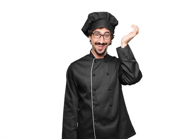 Young man chef happily realizing some good and surprising news or having a great idea