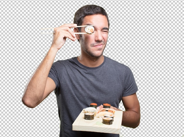 Young man eating sushi