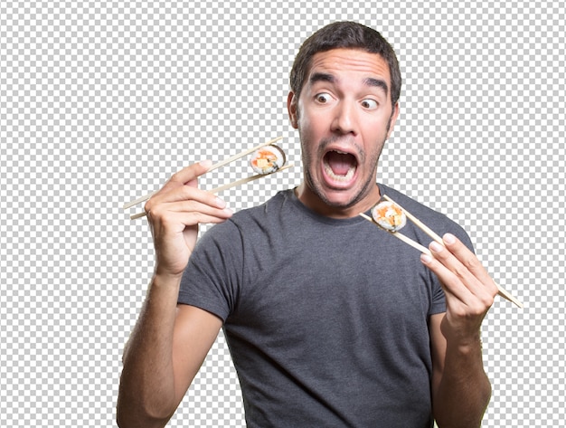 Young man eating sushi