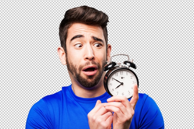 Young man holding an alarm clock