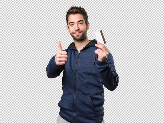 Young man holding a credit card and doing okay gesture