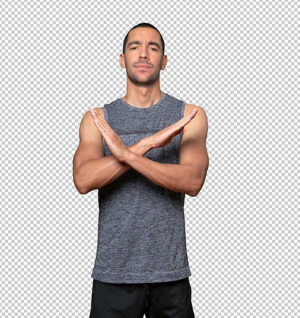 young man making a gesture of not crossing with the arms